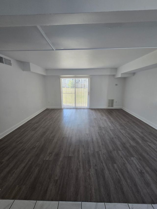 Living room with patio door at Chateau Apartments