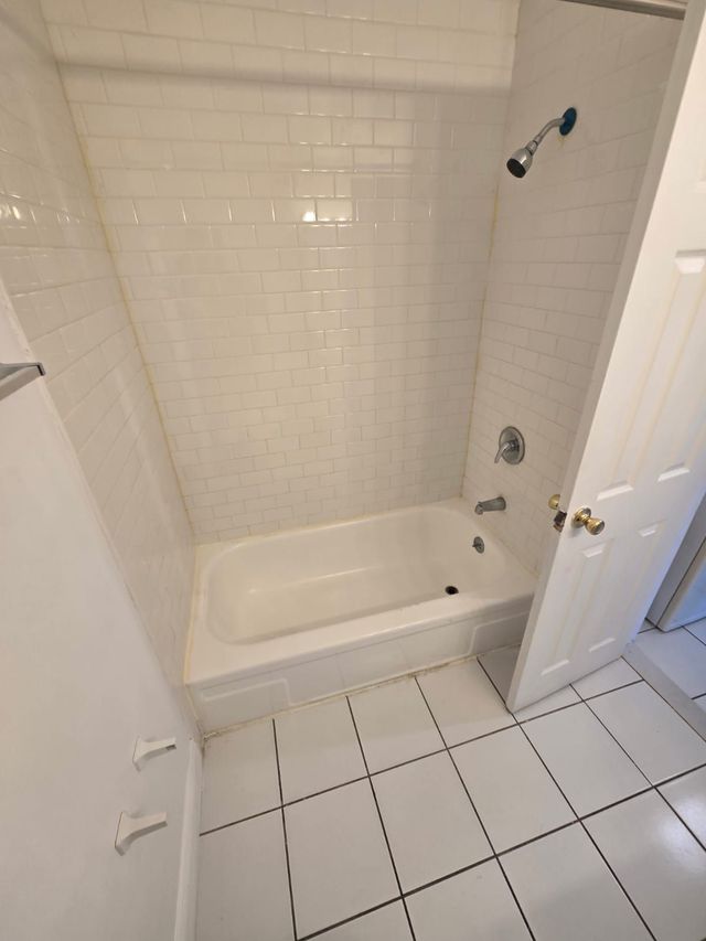 White bathroom with tub at Chateau Apartments