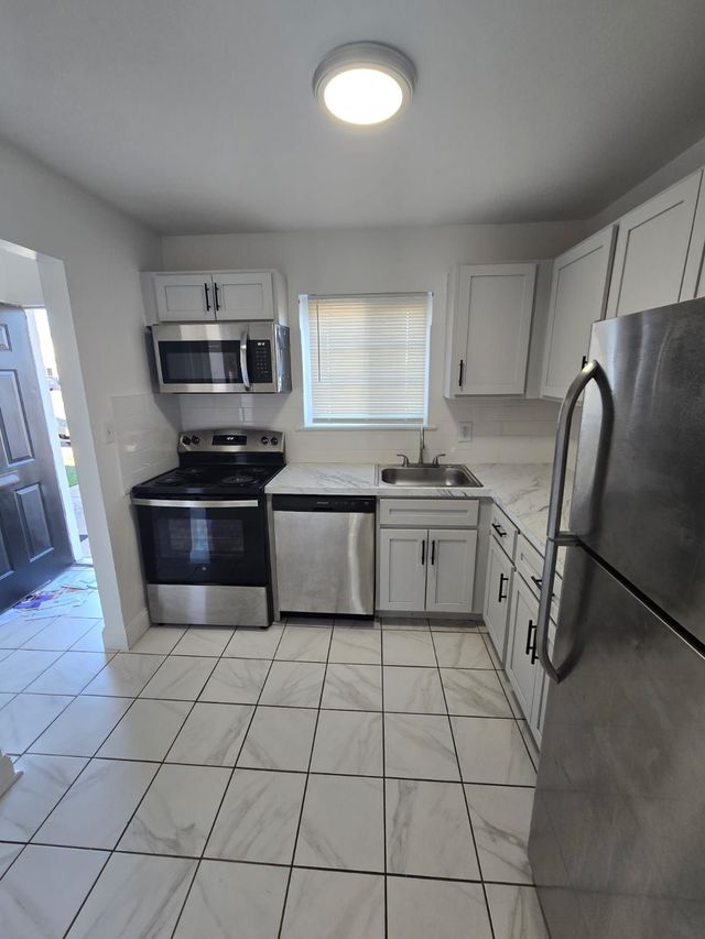 White kitchen with breakfast counter at Chateau Apartments