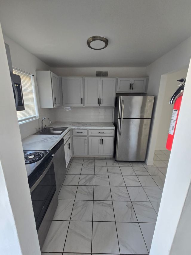White kitchen with modern finishes at Chateau Apartments
